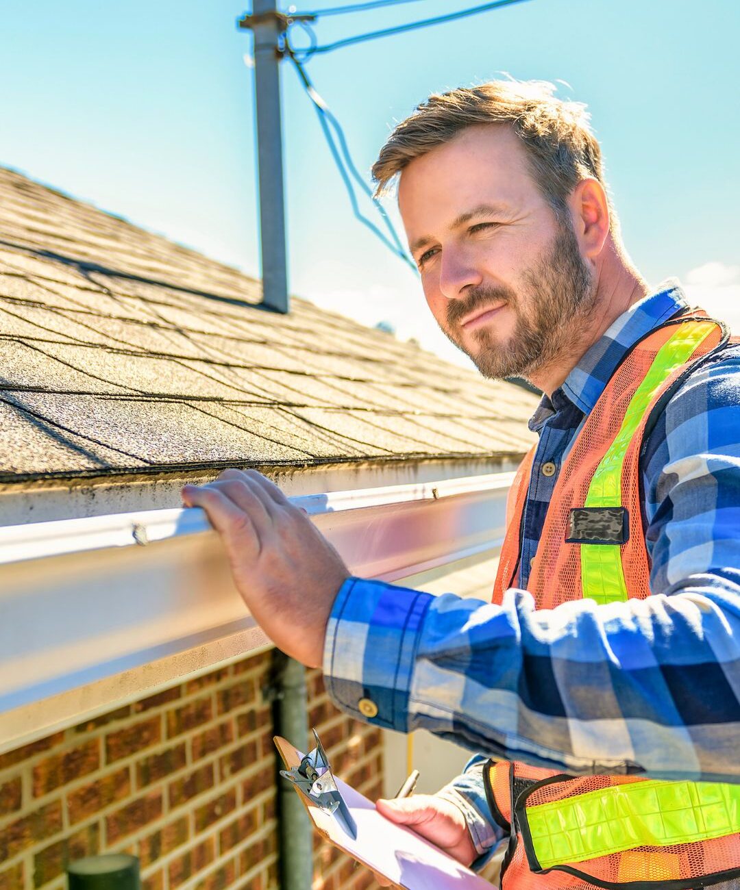 A licensed property inspector reviewing a roof system during a home inspection in Miami, Florida, highlighting the difference between inspection and appraisal.